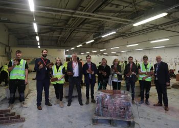 Ciaran and other individuals holding a brick